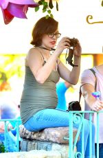 Pregnant MILLA JOVOVICH at Disneyland in Anaheim