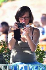 Pregnant MILLA JOVOVICH at Disneyland in Anaheim