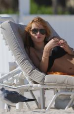 BELLA THORNE in Tiny Bikni on the Beach in Miami