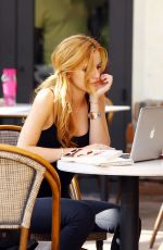BELLA THORNE Reading a Book at a Cafe in Los Angeles