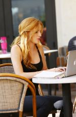 BELLA THORNE Reading a Book at a Cafe in Los Angeles