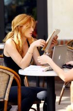 BELLA THORNE Reading a Book at a Cafe in Los Angeles