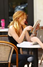 BELLA THORNE Reading a Book at a Cafe in Los Angeles