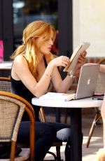 BELLA THORNE Reading a Book at a Cafe in Los Angeles