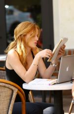 BELLA THORNE Reading a Book at a Cafe in Los Angeles