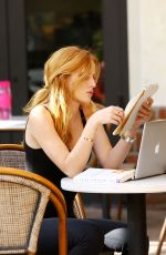 BELLA THORNE Reading a Book at a Cafe in Los Angeles
