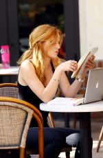 BELLA THORNE Reading a Book at a Cafe in Los Angeles