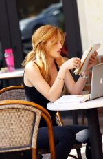 BELLA THORNE Reading a Book at a Cafe in Los Angeles