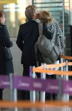 CHARLIZE THERON and Sean Penn Share a Kiss at LAX Airport
