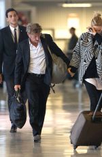 CHARLIZE THERON and Sean Penn Share a Kiss at LAX Airport