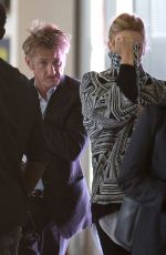 CHARLIZE THERON and Sean Penn Share a Kiss at LAX Airport
