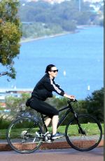 KATY PERRY in Tights Riding a Bicycle Out in Perth