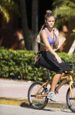 NINA AGDAL in Sport Bra and Leggings Riding a Bike Out in Miami