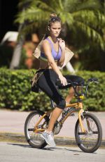 NINA AGDAL in Sport Bra and Leggings Riding a Bike Out in Miami