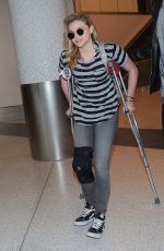 CHLOE MORETZ Sports Knee Brace at LAX Airport in Los Angeles