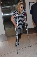 CHLOE MORETZ Sports Knee Brace at LAX Airport in Los Angeles