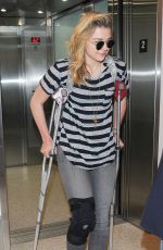 CHLOE MORETZ Sports Knee Brace at LAX Airport in Los Angeles