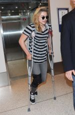 CHLOE MORETZ Sports Knee Brace at LAX Airport in Los Angeles