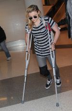 CHLOE MORETZ Sports Knee Brace at LAX Airport in Los Angeles