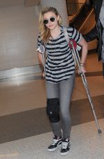 CHLOE MORETZ Sports Knee Brace at LAX Airport in Los Angeles