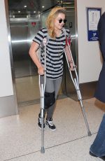 CHLOE MORETZ Sports Knee Brace at LAX Airport in Los Angeles