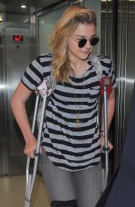 CHLOE MORETZ Sports Knee Brace at LAX Airport in Los Angeles