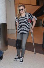 CHLOE MORETZ Sports Knee Brace at LAX Airport in Los Angeles