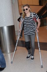 CHLOE MORETZ Sports Knee Brace at LAX Airport in Los Angeles