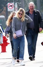 DAKOTA FANNIG Walks Her Dog Out in Los Angeles