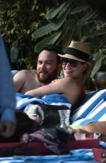 KATIE CASSIDY in Bikini Sunbathing at a Pool in Miami