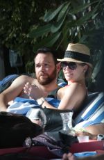 KATIE CASSIDY in Bikini Sunbathing at a Pool in Miami