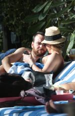 KATIE CASSIDY in Bikini Sunbathing at a Pool in Miami