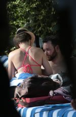 KATIE CASSIDY in Bikini Sunbathing at a Pool in Miami