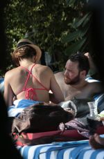 KATIE CASSIDY in Bikini Sunbathing at a Pool in Miami