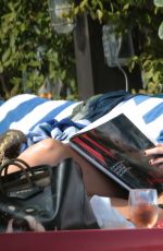 KATIE CASSIDY in Bikini Sunbathing at a Pool in Miami