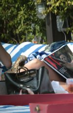 KATIE CASSIDY in Bikini Sunbathing at a Pool in Miami