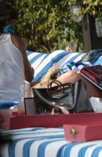 KATIE CASSIDY in Bikini Sunbathing at a Pool in Miami