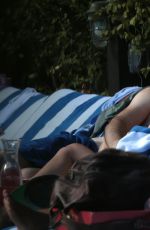 KATIE CASSIDY in Bikini Sunbathing at a Pool in Miami