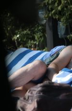 KATIE CASSIDY in Bikini Sunbathing at a Pool in Miami
