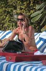 KATIE CASSIDY in Bikini Sunbathing at a Pool in Miami