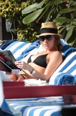 KATIE CASSIDY in Bikini Sunbathing at a Pool in Miami