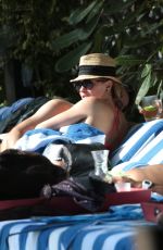 KATIE CASSIDY in Bikini Sunbathing at a Pool in Miami