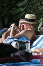 KATIE CASSIDY in Bikini Sunbathing at a Pool in Miami