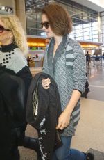 LILY COLLINS Arrives at Los Angeles International Airport