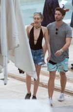 MILEY CYRUS and Patrick Schwarzenegger at a Pool in Miami