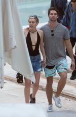 MILEY CYRUS and Patrick Schwarzenegger at a Pool in Miami