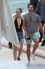 MILEY CYRUS and Patrick Schwarzenegger at a Pool in Miami