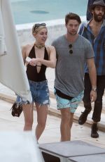 MILEY CYRUS and Patrick Schwarzenegger at a Pool in Miami