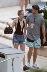 MILEY CYRUS and Patrick Schwarzenegger at a Pool in Miami