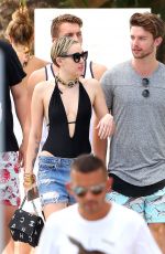 MILEY CYRUS and Patrick Schwarzenegger at a Pool in Miami